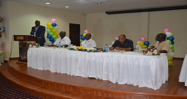 Minister of State, Joseph Harmon addressing the gathering. Also in photo, at head table, are: (from left) Mr. Newell Dennison, Chairperson; Mr. Rickford Vieira, Commissioner, GGMC; Minister of Governance, Raphael Trotman and Dr. Grantley Walrond, Former Commissioner, GGMC