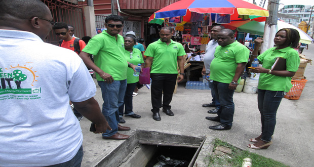 Town Clerk Royston King and members of the team inspecting drains along Regent Street yesterday during their walkabout