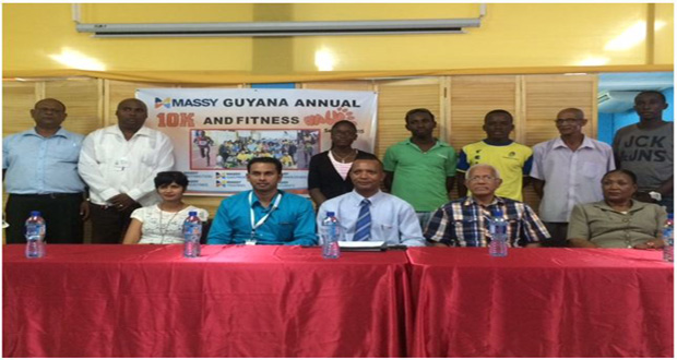 Some of the athletes to participate at the Massy 10km Road Race pose with representatives from the Massy Group of Companies and AAG.