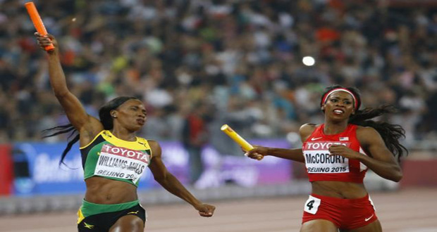 Novlene Williams-Mills of Jamaica (L) crosses the finish line beside Francena McCorory of the U.S. in the women's 4x400 metres relay final at the 15th IAAF Championships at the National Stadium in Beijing, China. (Reuters/Damir Sagolj)