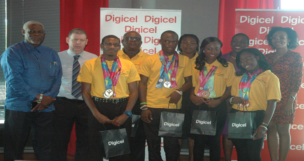 Special Olympics World Games athletes (front row) - Calvin Thomas, Kevin Pryce, Annisa Bowman and Deandra David, flanked by Digicel CEO Kevin Kelly (second from left), and Minister of Sport, Nicolette Henry (second from right).