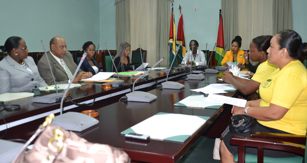Minister within the Ministry of Social Protection, Simona Broomes and Minister of Governance, Raphael Trotman (left and second left respectively) meeting Thursday with members of the Guyana Women Miners Organisation at Committees Room, Parliament Building 