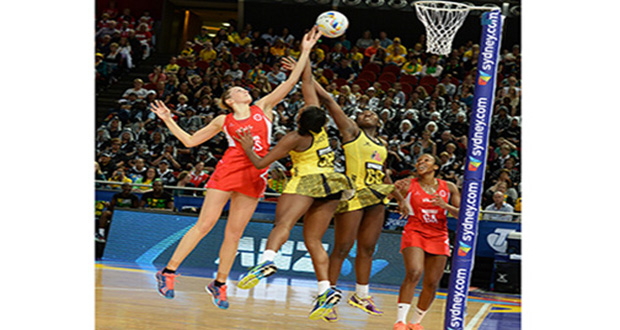 Jamaica's defenders Stacian Facey and Vangelee Williams (right) go high with England's Joanne Harten and Pamela Cookey (GA) in their bronze-medal match yesterday. (Jamaica Observer photo.).
