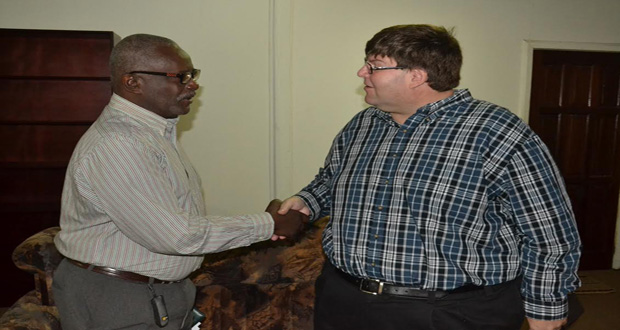 Minister of Citizenship, Winston Felix, greets U.S. Chargé d'Affaires to Guyana, Bryan Hunt, before the beginning of the meeting at his office