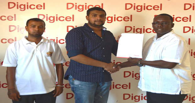 Digicel’s Events and Sponsorship manager Gavin Hope presents the cheque to Nazrudeen Mohammed Jr, a member of the Guyana Cup Organising Committee, in the presence of Rovin DeSouza.