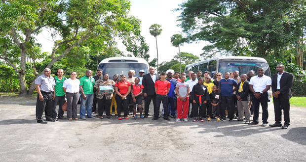 Beneficiaries of the National Sports Commission grants stand with the Director of Sport Christopher Jones. (Delano Williams photo)