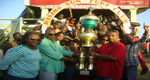 Minister of State Joseph Harmon with Minister in the Ministry of Public Infrastructure Annette Ferguson among other officials as the Ramesh Sunich-sponsored President’s Cup is presented to Chris Jagdeo, owner of Just Call Me Boss.