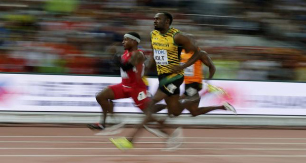 Mike Rodgers of the U.S. (L) and Usain Bolt of Jamaica (C) competes in the men's 100 metres heats during the 15th IAAF World Championships at the National Stadium in Beijing, China yesterday.