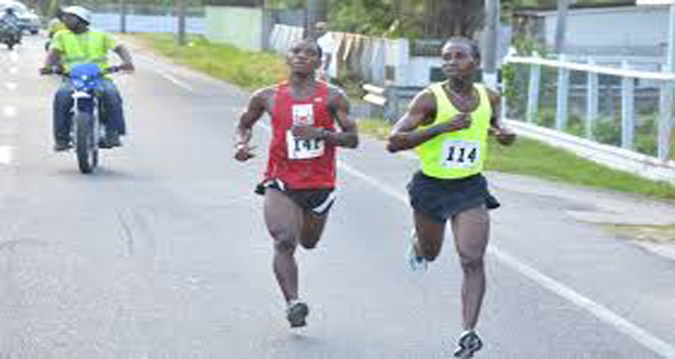 FLASHBACK: Cleveland Thomas (right) crosses the finish line ahead of Kelvin Johnson to win the 4th Annual COURTS 10K run.