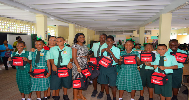 Students of Kingston Secondary posing with their back-to-school bags on Monday, compliments of Digicel