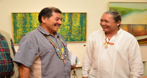 Minister of Indigenous People’s Affairs Sydney Allicock and artist George Simon enjoy a light moment at the opening of the exhibition.