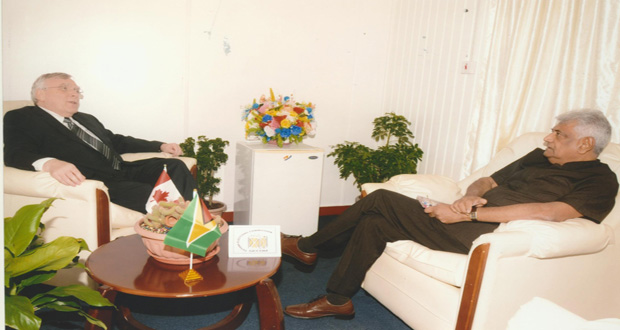 Canadian High Commissioner Mr. Pierre Giroux and GECOM’s Dr Steve Surujbally in talks Tuesday at the latter’s upper High Street, Kingston office