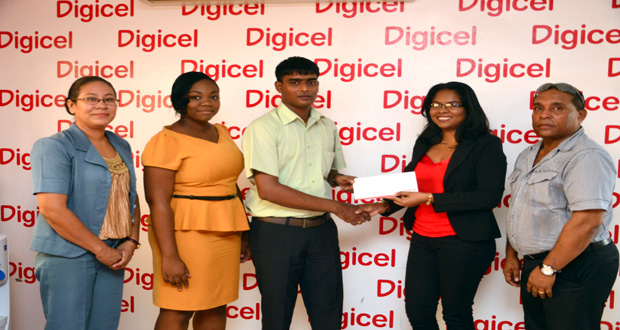 Digicel Communications Manager Vidya Bijlall-Sanichara handing over the cheque Wednesday to Besham Ramsaywack, Project Officer/Heritage Coordinator With them are, from left, Elke Rodrigues, Louanna Abrams, and Ivan Persaud (Photo by Adrian Narine)