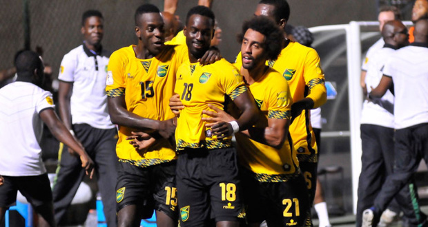 Jamaica's Simon Dawkins (#18) is mobbed by teammates after scoring the World Cup Qualifying series-clinching goal against host Nicaragua on Tuesday night in Managua. (Photo: www.pinolerosports.com)