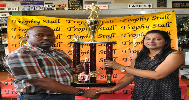 Trophy Stall’s Devi Sunich (right) presents one of the trophies to Petra Organisation Co-Director, Troy Mendonca, on Friday.