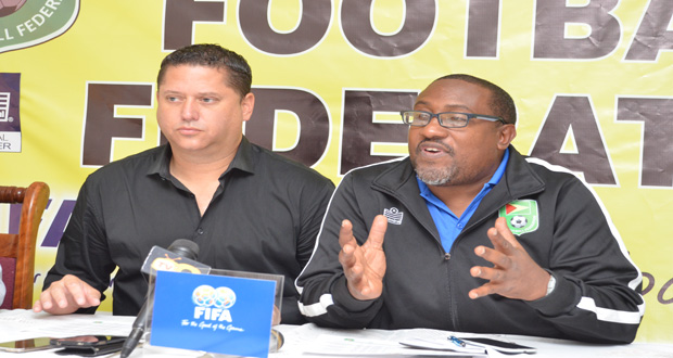 Golden Jaguars head coach Jamaal Shabazz makes a point during the launch of the Stag Elite League fixtures while GFF technical director Claude Bolton listens in. (Delano Williams photo)