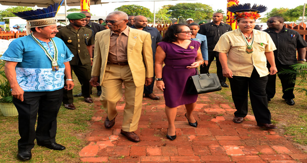 President David Granger interacts with Minister of Indigenous Affairs, Sydney Allicock on arrival at ‘Heritage Village’ for the launch of Indigenous Heritage Month 2015 (Photo by Adrian Narine)
