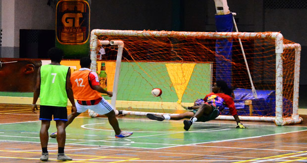 Stellon David scores for Bent Street against Sophia in their GT Beer Futsal quarter-final match at the Cliff Anderson Sports Hall on Sunday night.