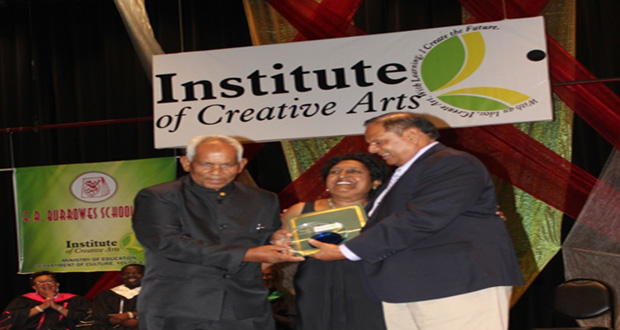 Prime Minister Moses Nagamootoo (right) presents the ICA Lifetime Achievement Award to drum master, Mr. Mangal Raghunandan