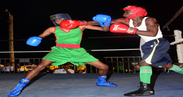 Dexter Wray (right) of the Republican Boxing Gym connects with an overhand right to the head of Guyana Defence Force’s Aluko Venture during their flyweight contest. The former won the bout by a unanimous points decision. (Photo by Adrian Narine)