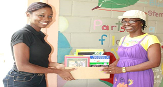 Book donation by Ms Denisha Victor (President, Rotaract Club Georgetown Central) to Ms Babb (Founder, Ruimveldt Children’s Home and Care Centre)