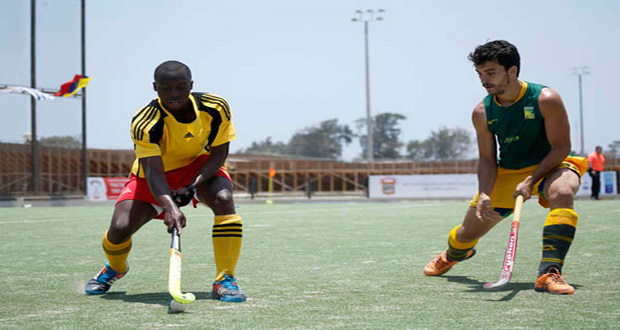 Guyana’s Aroydy Branford controls the ball while being challenged by a Brazilian player during yesterday’s match in the Pan American Hockey Challenge in Chiclayo, Peru