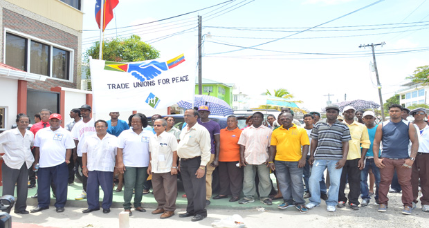 Trade unionists and workers outside the Embassy of the Bolivarian Republic of Venezuela in Georgetown yesterday before presenting the Ambassador with a signed Peace Declaration