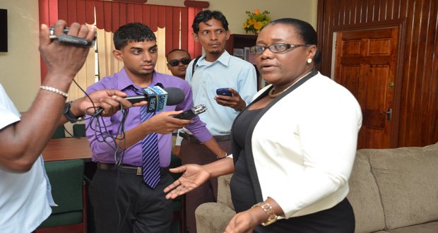 Minister Broomes speaking with journalists at her office yesterday afternoon