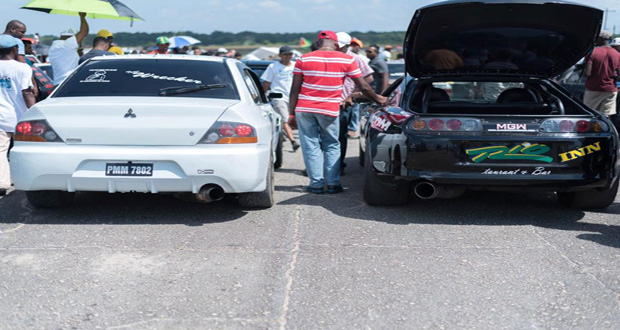 Side by side: the Mitsubishi Evolution of Winston Wada (left) sits alongside the Drag king Rondel Dabi's Toyota Supra (right). (Sean Charles photo)