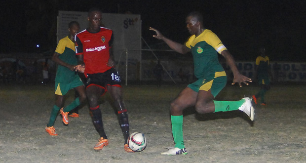 GDF skipper Selwyn Isaacs and Clive Matthews battle for a loose ball at the Tucville ground on Friday. (Delano Williams photo)