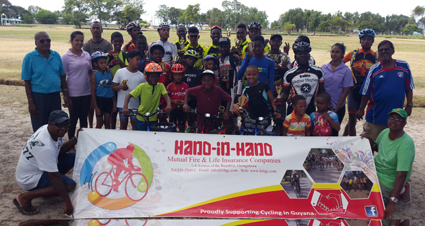 Prize-winners of the various categories in yesterday’s 11th annual Hand-in-Hand 11-race cycle programme strike a pose with the sponsor’s secretary. Savita Singh (second left), and race organiser Hassan Mohamed (extreme left).