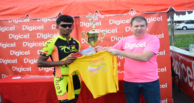 Raynauth `Obeahman’ Jeffrey” left accepts the winners yellow jersey along with his cheque and trophy from Digicel’s CEO Kevin Kelly for winning the 4th annual sponsored Cancer Awareness Two-Stage cycle road race yesterday (Photo by Samuel Maughn).