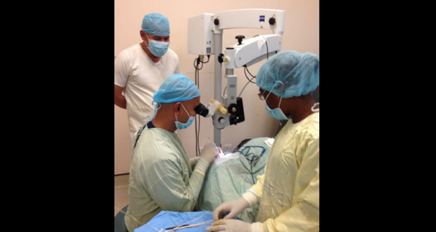 Minister of Public Health Dr George Norton at GPHC’s Eye Theatre, observing as Dr Ronnie Bhola conducts a surgery
