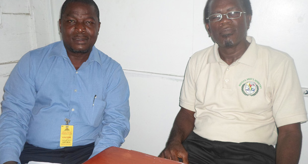From left:  Brother Fenton Park, Coordinator of the Adventist Men’s Ministries in Guyana, and Pastor Dennis Hamilton, Director of the Adventist Men’s Ministries, speaking with the Guyana Chronicle