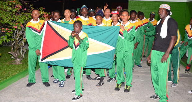 The Guyana boxing contingent display the Golden Arrowhead on the opening night of the tournament. (Delano Williams photo)