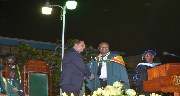 Prime Minister Moses Nagamootoo shakes the hand of recipient of the 2015 Prime Minister’s Medal for best graduating student in Public Management, Superintendent of Police Brian Eastman