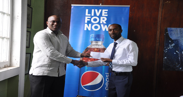 GABA President Steve Ninvalle (left) collects sponsorship from DLL Brand Manager Larry Wills for the upcoming Caribbean Development Boxing Tournament.