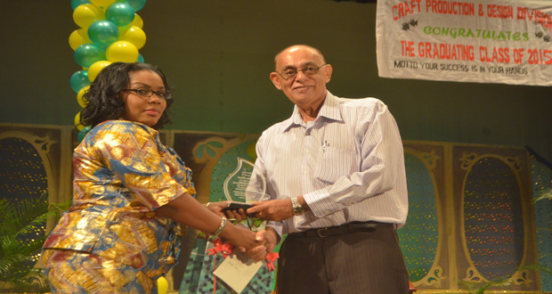 Administrator of the Craft and Design Division, Mrs Kim Gordon, handing over an award to former Chairman of the school’s Board of Directors, John Seeram (Photos by Cullen Bess-Nelson)