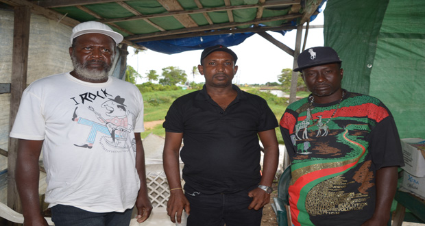 Three of the distraught fishermen after being fired at Prettipaul Investments. (Photo by Delano Williams)