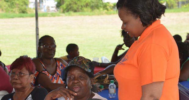 Social Protection Minister Volda Lawrence interacting with one of the foster parents during the fun day at YMCA