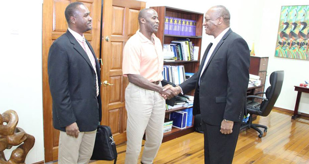 GFF Wayne Forde looks on while 1st VP Brigadier (rtd) Jullian Bruce Lovell greets Minister of State Joseph Harmon. (Photo courtesy of the Ministry of the Presidency)
