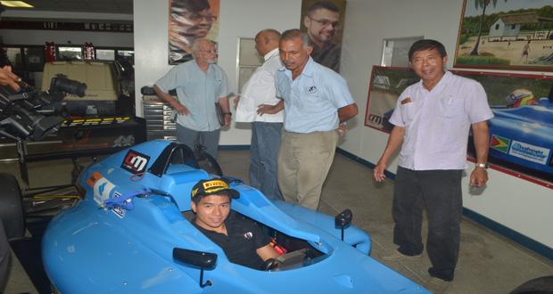 Calvin Ming is seated in his Formula 4 car. Looking on is veteran motor-racer Andrew King and his father Stanley Ming. (Cullen Nelson Photo)
