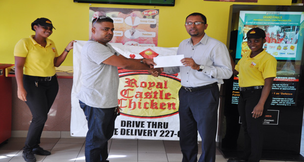 Royal Castle’s General Manager, Tribhowan Brasse (right), hands over the sponsor’s cheque to Team Xtreme’s Manager David Bacchus yesterday.