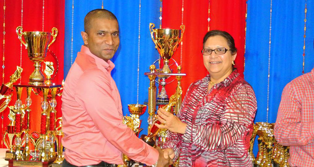 Dant’s Hemnarine Chattergoon collects his Grand Champion MVP award for Consul General Ms. Sattie Sawh.