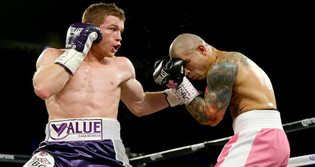 Canelo Alvarez lands a left hook against Miguel Cotto during their WBC middleweight fight on Saturday night in Las Vegas`.(Al Bello / Getty Images)