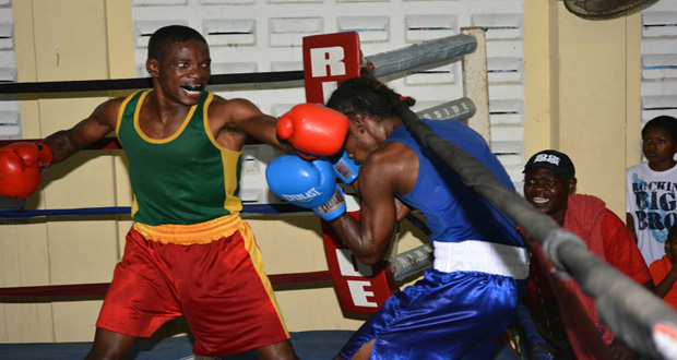 Part of the action in Sunday’s final of the bantamweight category between GDF’s Clairmont Gibson (left) and FYF’s Delon Charles. (Samuel Maughn photo)
