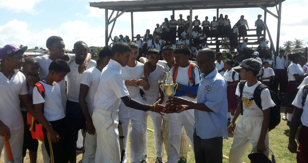 Javed Karim receives the winning trophy for his team from the West Berbice President, David Black.
