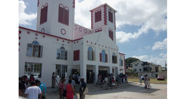 A hive of activity among worshippers after the first Mass at the newly-rebuilt Sacred Heart Roman Catholic Church on Main Street yesterday