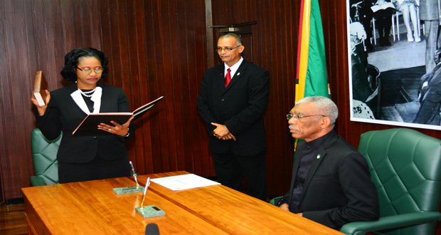 Justice Yonette Cummings-Edwards takes her oath of office before President David Granger on Wednesday at the Ministry of the Presidency.