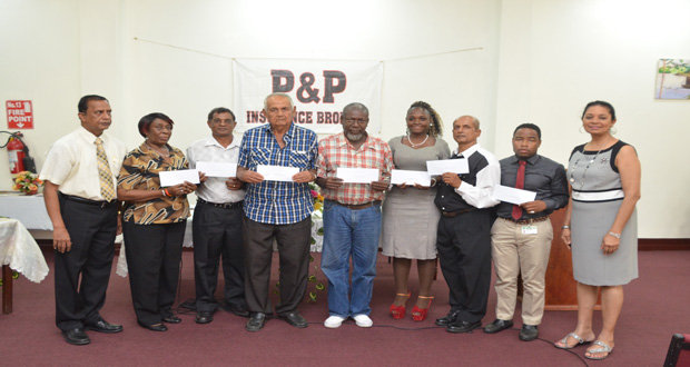 P&P Insurance Brokers and Consultants Limited Director Bish Panday (left) and Mrs Panday (right) with the beneficiaries (Delano Williams photo)